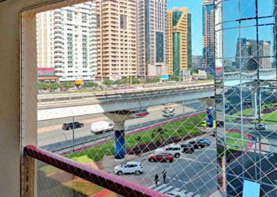 Child-safety-netting-on balcony-over-busy-Dubai-road